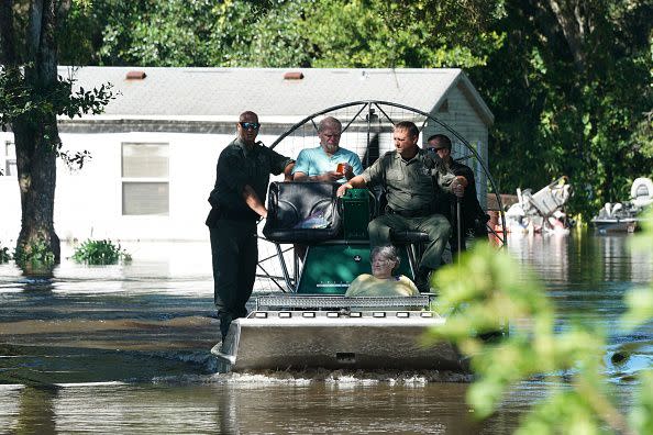Osceloa County Sheriffs use a fanboat to rescue residents from flooding following Hurricane Ian on September 30, 2022 in Kissimmee, Florida. - Forecasters expect Hurricane Ian to cause life-threatening storm surges in the Carolinas on Friday after unleashing devastation in Florida, where it left a yet unknown number of dead in its wake. After weakening across Florida, Ian regained its Category 1 status in the Atlantic Ocean and was headed toward the Carolinas, the US National Hurricane Center said Friday. (Photo by Bryan R. Smith / AFP) (Photo by BRYAN R. SMITH/AFP via Getty Images)