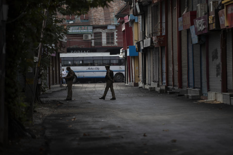 Indian paramilitary soldiers keep guard during restrictions in Srinagar, Indian controlled Kashmir, Friday, Aug. 28, 2020. Police and paramilitary soldiers on Friday detained dozens of Muslims participating in religious processions in the Indian portion of Kashmir. Authorities had imposed restrictions in parts of Srinagar, the region's main city, to prevent gatherings marking Muharram from developing into anti-India protests. (AP Photo/Mukhtar Khan)