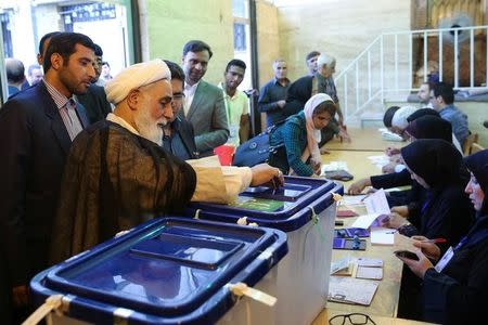 Ali Akbar Nategh-Nouri casts his vote into a ballot box during the presidential election in Tehran, Iran, May 19, 2017. TIMA via REUTERS