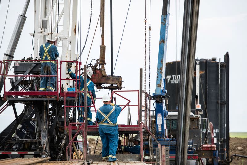 Crew members work at Royal Helium's Climax 3 drill site near Climax