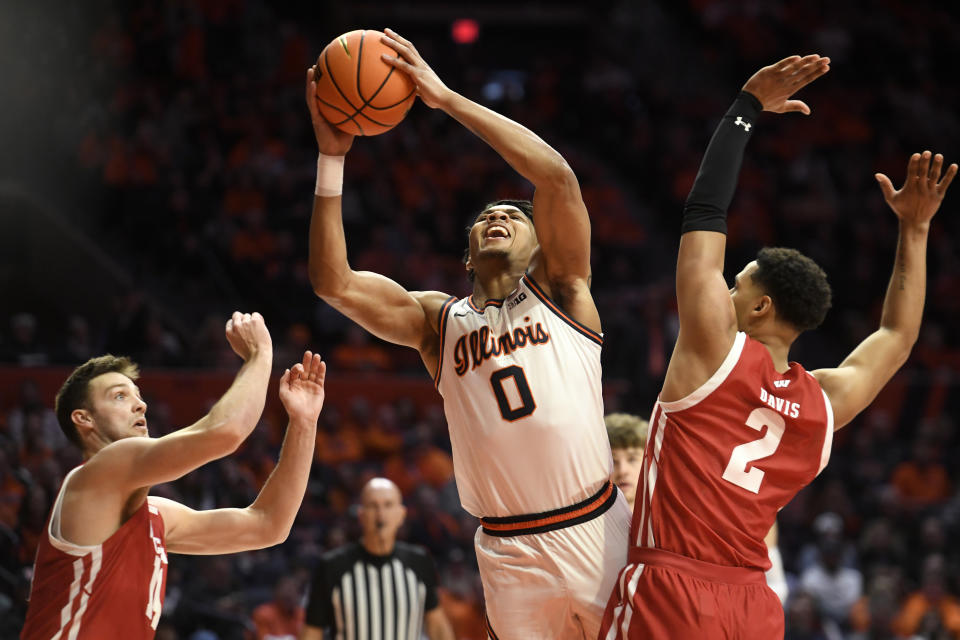 Illinois' Terrence Shannon Jr. (0) shoots between Wisconsin's Jordan Davis (2) and Carter Gilmore (14) \ during the first half of an NCAA college basketball game, Saturday, Jan. 7, 2023, in Champaign, Ill. (AP Photo/Michael Allio)