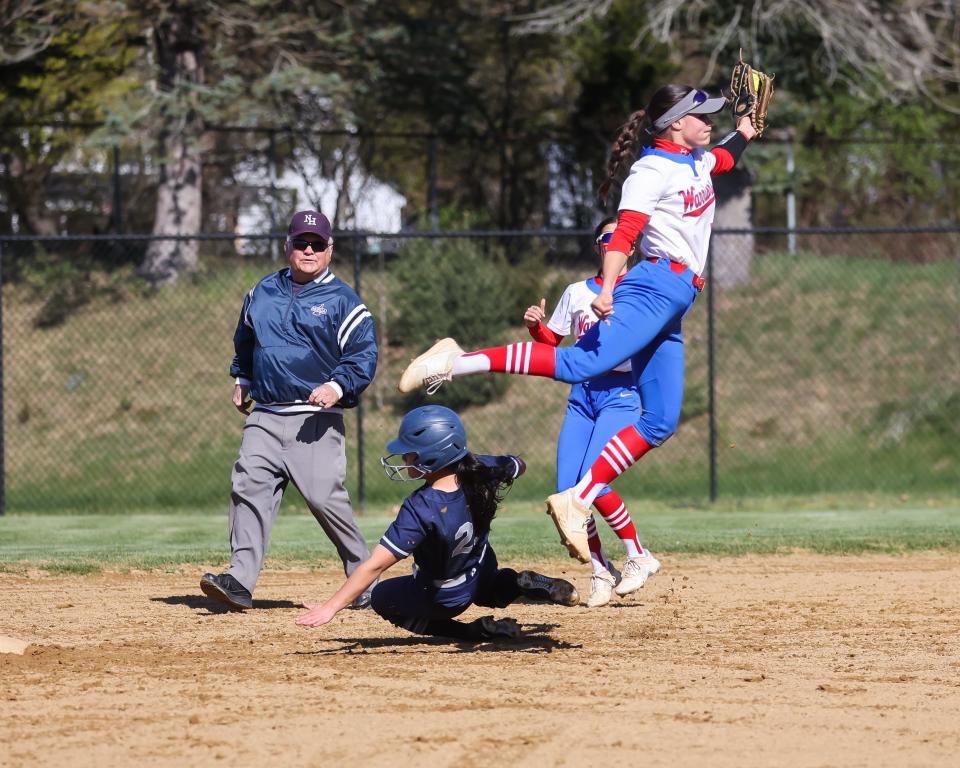 A high throw to Winnacunnet shortstop Kate Gagne allows Exeter's Annie Christiana to slide in for a steal during Friday's Division I softball game.