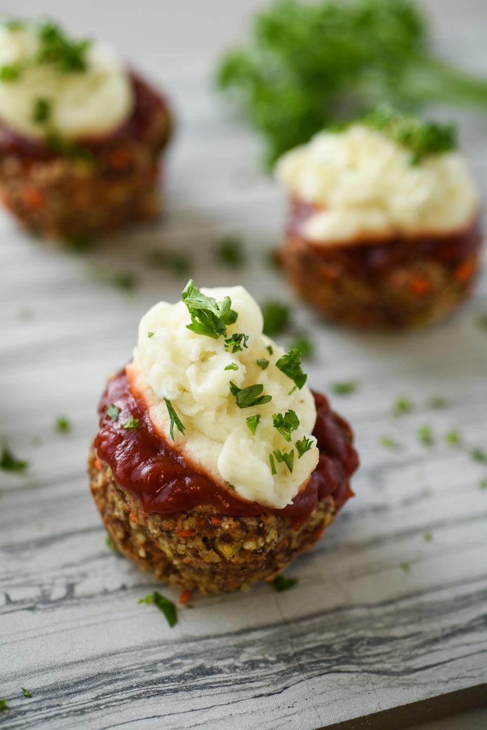 Meatloaf cupcakes are topped with mashed potatoes.