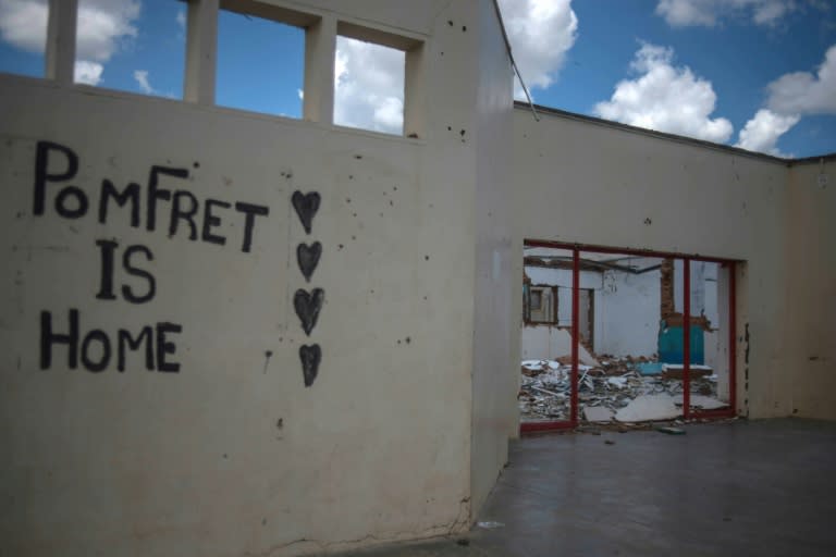 Graffiti on a dilapidated building in the desert town of Pomfret, South Africa. By the 2000s, the government signalled its intention to close the base in Pomfret and to relocate the remaining families. But a hard core of ex-servicemen refused to budge