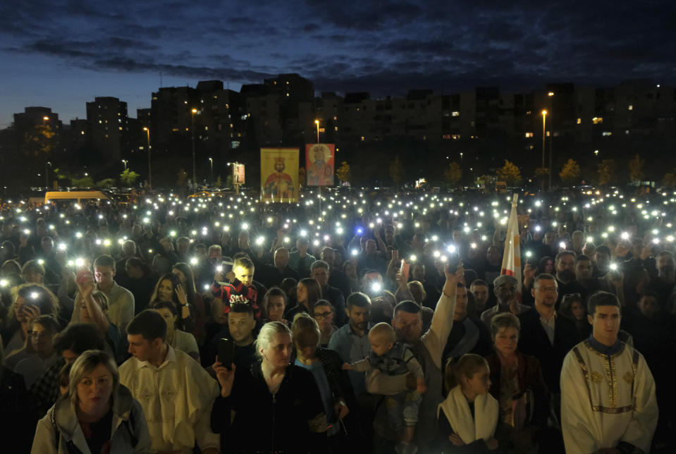 People gather for a protest prayer led by the Serbian Orthodox Church against the holding of an LGBTQ pride march this weekend in Podgorica, Montenegro, Friday, Oct. 7, 2022. The influential church has called its followers in Montenegro to join the prayer for "the sanctity of marriage and preservation of family" after organizing a similar gathering in neighboring Serbia ahead of a pan-European pride event there last month. (AP Photo/Risto Bozovic)