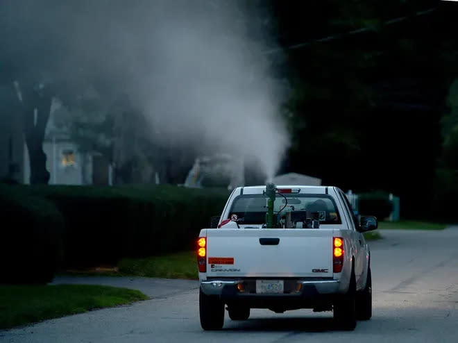 An East Middlesex Mosquito Control truck sprays a pesticide for mosquitoes on Kittredge Road in Framingham in this 2017 file photo.