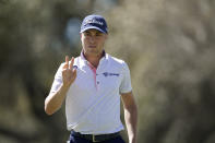 Justin Thomas waves after putting on the sixth green in the second round of the Dell Technologies Match Play Championship golf tournament, Thursday, March 24, 2022, in Austin, Texas. (AP Photo/Tony Gutierrez)