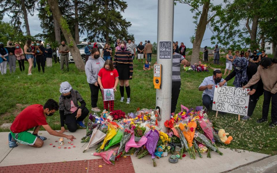 Mourners pay their respects in London, Ontario - Brett Gundlock/The Canadian Press via AP