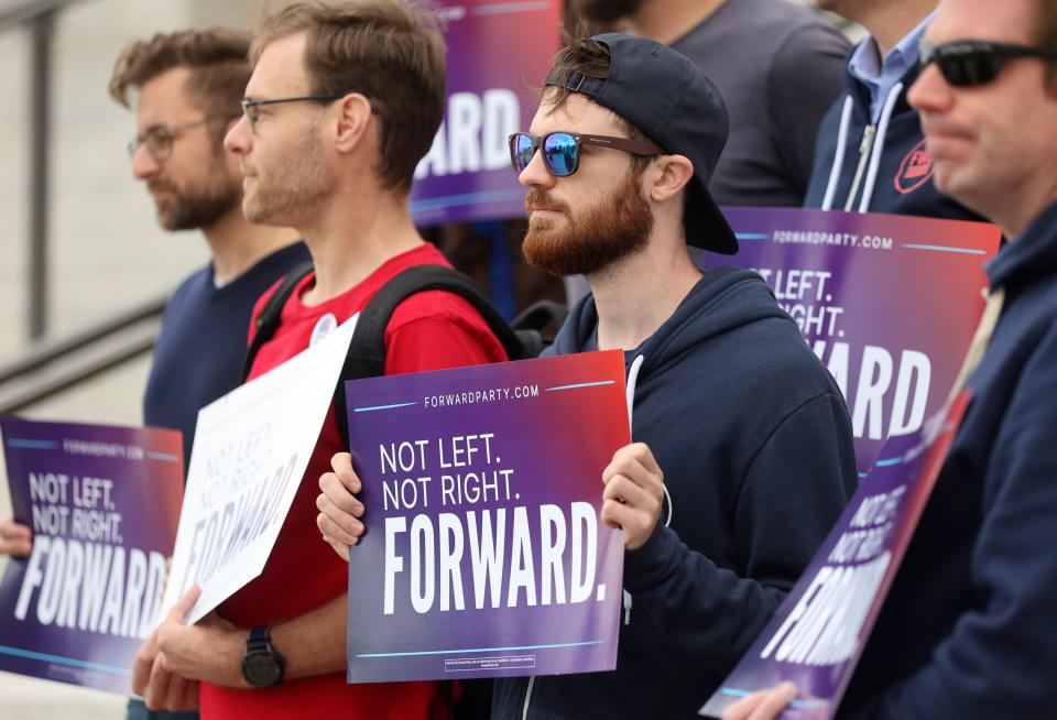 Supporters hold signs during a press conference to announce Utah Forward Party’s collection of more than 2,000 petition signatures, which is required to put the party on voting ballots, outside of the Capitol in Salt Lake City on Wednesday, Oct. 11, 2023. | Kristin Murphy, Deseret News