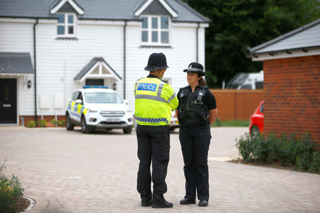 Police officers stand in front of a housing development on Muggleton Road, which has been cordoned off after two people were hospitalised and police declared a 'major incident', in Amesbury, Wiltshire, Britain, July 4, 2018. REUTERS/Henry Nicholls