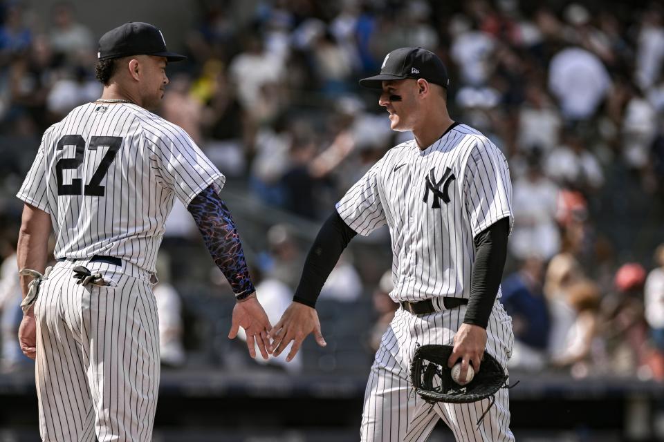 July 23, 2023;  Bronx, New York, USA;  New York Yankees first baseman Anthony Rizzo (48) and New York Yankees designated hitter Giancarlo Stanton (27) slap ands after winning against the Kansas City Royals at Yankee Stadium.  Mandatory Credit: John Jones-USA TODAY Sports