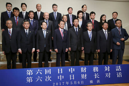 Chinese Finance Minister Xiao Jie, front row fourth from right, Japanese Finance Minister Taro Aso, front row fourth from left, pose for a photo with Japan's and China's executives of Finance Ministry and Central Bank during their bilateral meeting, on the sideline of Asian Development Bank annual meeting, in Yokohama, near Tokyo, Saturday, May 6, 2017. REUTERS/Koji Sasahara/Pool