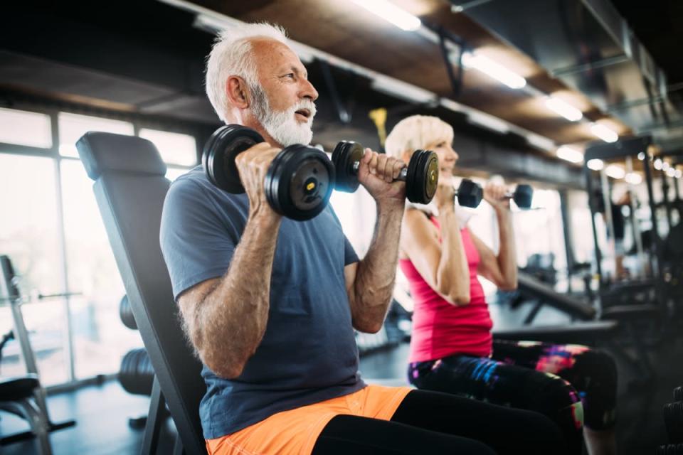 older couple exercising at gym