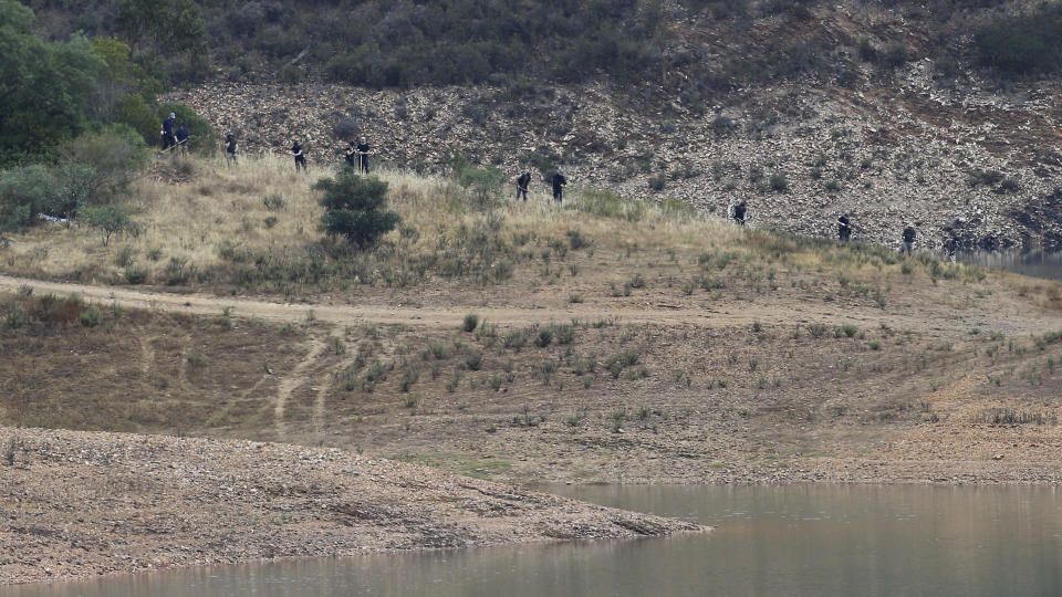 Police work by the banks of the Arade dam near Silves, Portugal, Tuesday May 23, 2023. Portuguese police aided by German and British officers have resumed their search for Madeleine McCann, the British child who disappeared in the country's southern Algarve region 16 years ago. Some 30 officers could be seen in the area by the Arade dam, about 50 kilometers (30 miles) from Praia da Luz, where the 3-year-old was last seen alive in 2007. (AP Photo/Joao Matos)