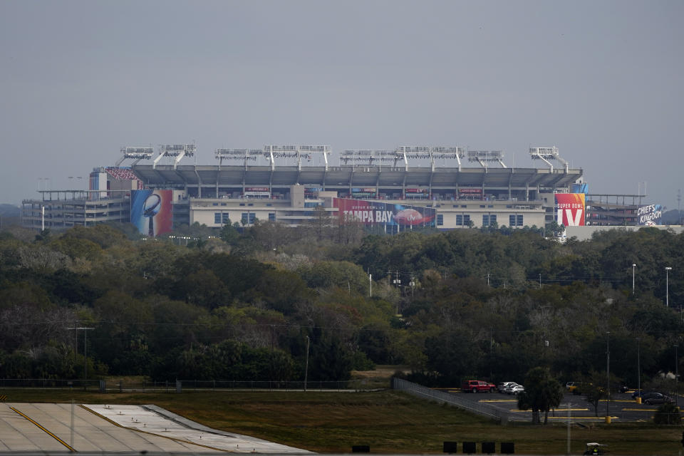 Raymond James Stadium rises in the distance ahead of Super Bowl 55 Saturday, Feb. 6, 2021, in Tampa, Fla. The venue is hosting Sunday's Super Bowl football game between the Tampa Bay Buccaneers and the Kansas City Chiefs. (AP Photo/Charlie Riedel)