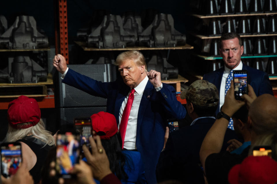 TOPSHOT - Former US President and 2024 presidential hopeful Donald Trump gestures while speaking at Drake Enterprises, an automotive parts manufacturer and supplier, in Clinton, Michigan, on September 27, 2023. Both Trump and Biden are visiting Michigan this week, in what is their first major skirmish of a long fight for voters in working-class swing states ahead of the November 2024 election. Biden on September 26, 2023, became the first sitting president to stand on a picket line, supporting calls by the United Auto Workers (UAW) union for the Big Three Detroit carmakers to raise wages. And Trump is skipping a debate in California with his trailing Republican rivals on September 27 to head instead for a small, non-union car parts factory on the other side of Detroit. (Photo by Matthew Hatcher / AFP) (Photo by MATTHEW HATCHER/AFP via Getty Images)