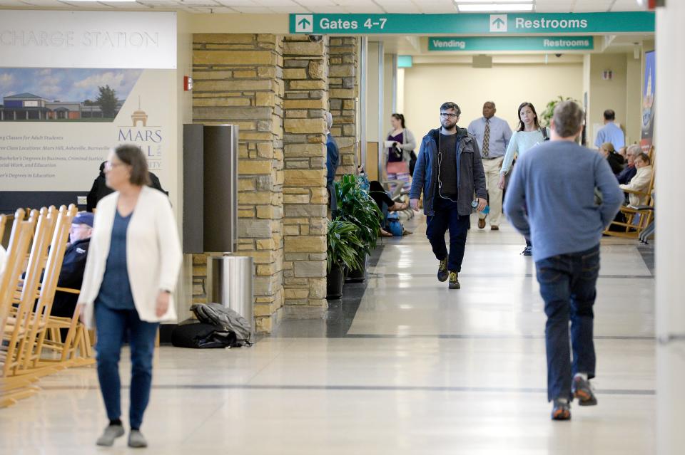 Passengers walk between gates at the Asheville Regional Airport on March 27, 2019. 