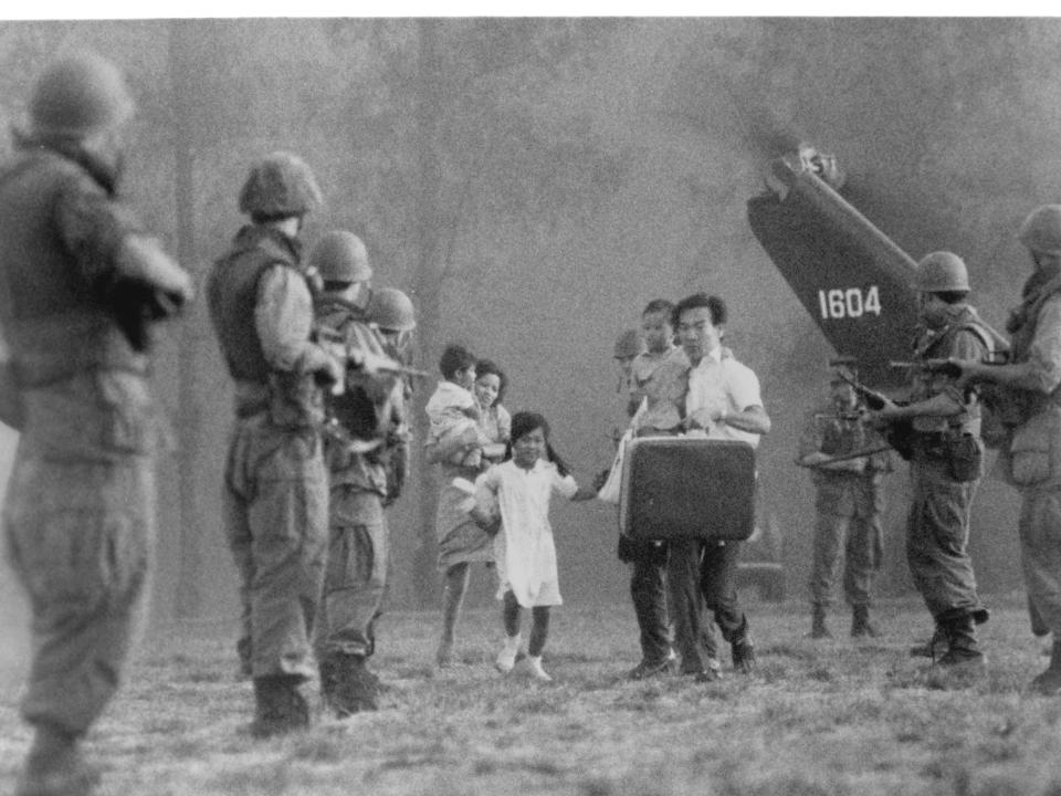 Haing S Ngor holds his children as he is lead by militia in a scene from the film "The Killing Fields," in 1984.