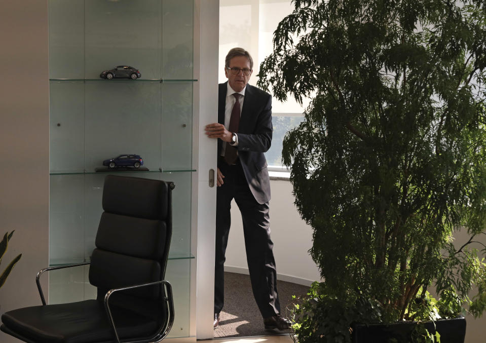 In this photo taken Friday, Oct. 12, 2018, Volkswagen Group China chief executive Jochem Heizmann walks out for an interview in Beijing. More than 200 manufacturers, including Tesla, Volkswagen, BMW, Daimler, Ford, General Motors, Nissan, Mitsubishi and U.S.-listed electric vehicle start-up NIO, transmit position information and dozens of other data points to government-backed monitoring centers, The Associated Press has found. Generally, it happens without car owners' knowledge. (AP Photo/Ng Han Guan)