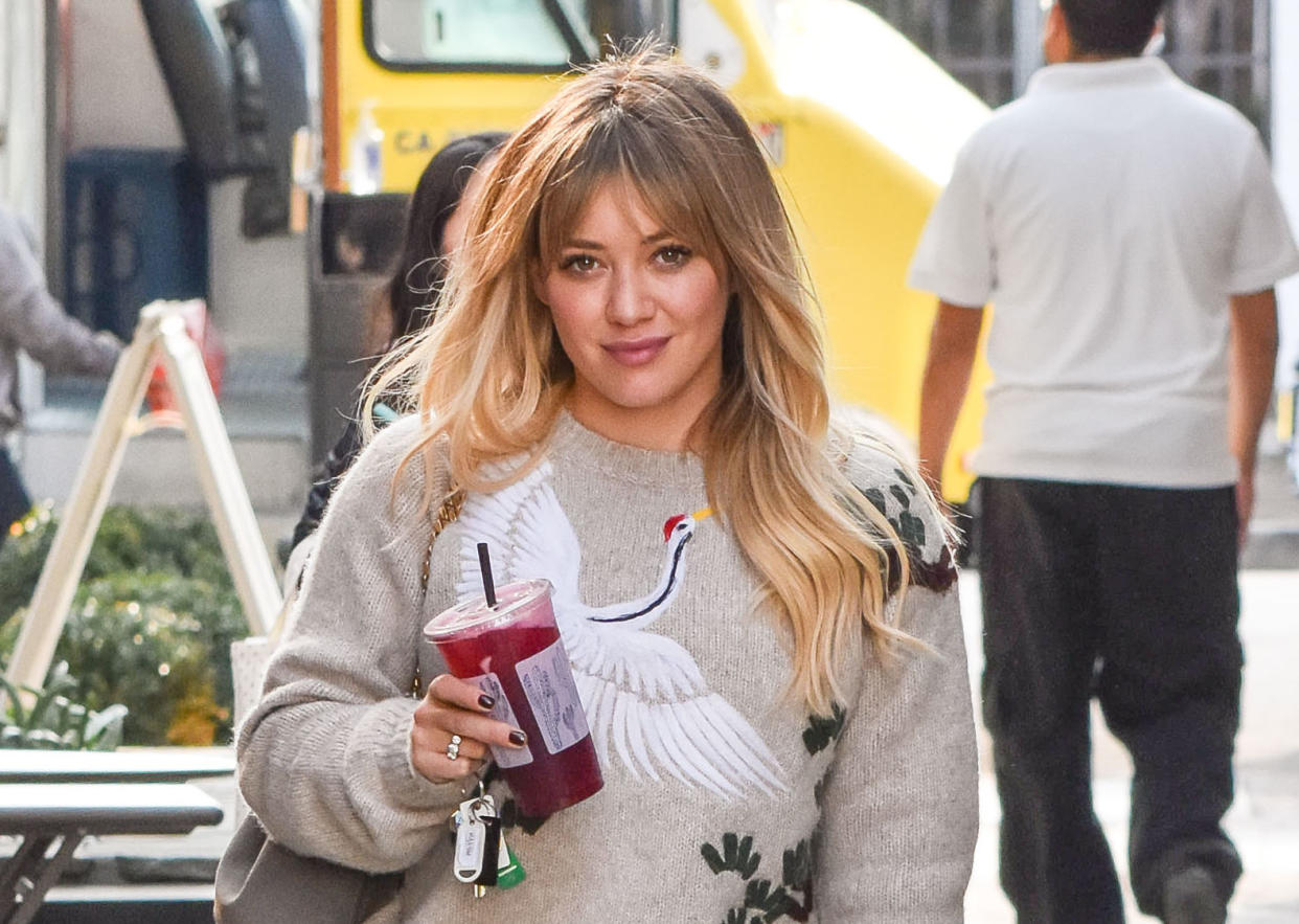 Hilary Duff rocking matching pajamas and space buns for the season is total #holidaygoals