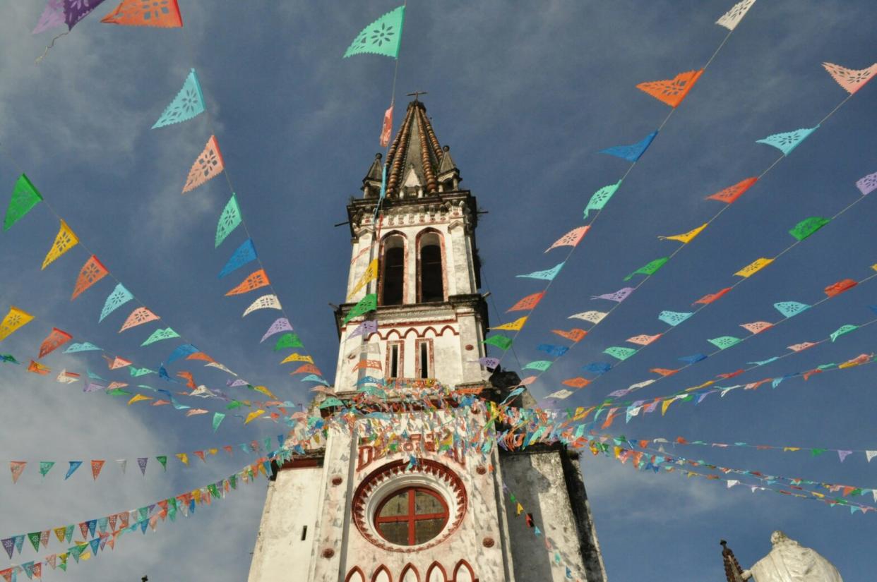 colorful flags hanging from historic building