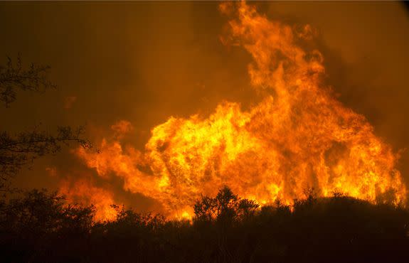 Flames from a massive wildfire burn, in Napa, California  on October 9, 2017.