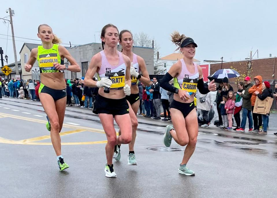 Sutton's Jessie Cardin, far right, runs in the 2023 Boston Marathon Monday.