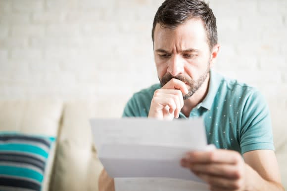 Man closely examining a document