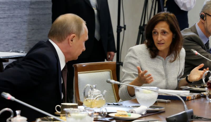 FILE PHOTO: Russian President Putin and Global News Editor of Reuters Galloni attend meeting with heads of leading global news agencies in St. Petersburg