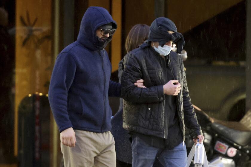 Former FBI informant Alexander Smirnov, left, walks out of his lawyer's office in downtown Las Vegas after being released from federal custody Tuesday, Feb. 20, 2024. Prosecutors say that Smirnov, who is charged with making up a multimillion-dollar bribery scheme involving President Joe Biden, his son Hunter and a Ukrainian energy company, had contacts with Russian intelligence-affiliated officials. (K.M. Cannon/Las Vegas Review-Journal via AP)