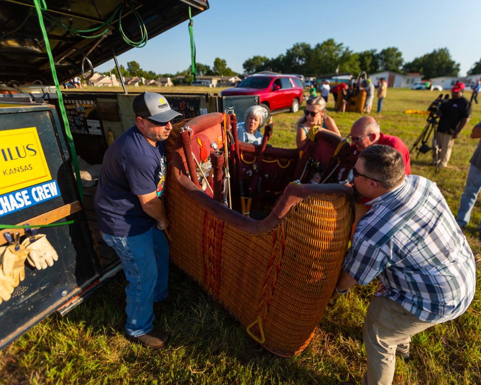 Tony Goodnow and several family members and friends unload the basket for the Libertas hot air balloon. Fully loaded with fuel, the wicker basket weighs about 500 pounds, excluding the pilot and any travelers.