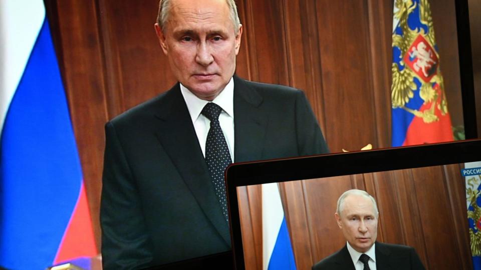 Russian President Vladimir Putin is seen on monitors as he addresses the nation after Yevgeny Prigozhin, the owner of the Wagner Group military company, called for armed rebellion, June 24, 2023. (Sputnik, via AP)