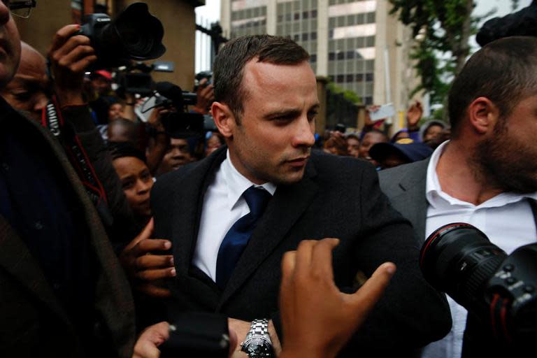 South African paralympic athlete Oscar Pistorius arrives to attend a hearing on the sixth day of his trial for the 2013 murder of his girlfriend, on March 10, 2014 at the high court in Pretoria