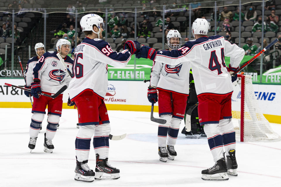 Columbus Blue Jackets defenseman Vladislav Gavrikov (44) is congratulated by teammate Jack Roslovic (96) after scoring a goal during the first period of an NHL hockey game against the Dallas Stars Saturday, April 17, 2021, in Dallas. (AP Photo/Sam Hodde)