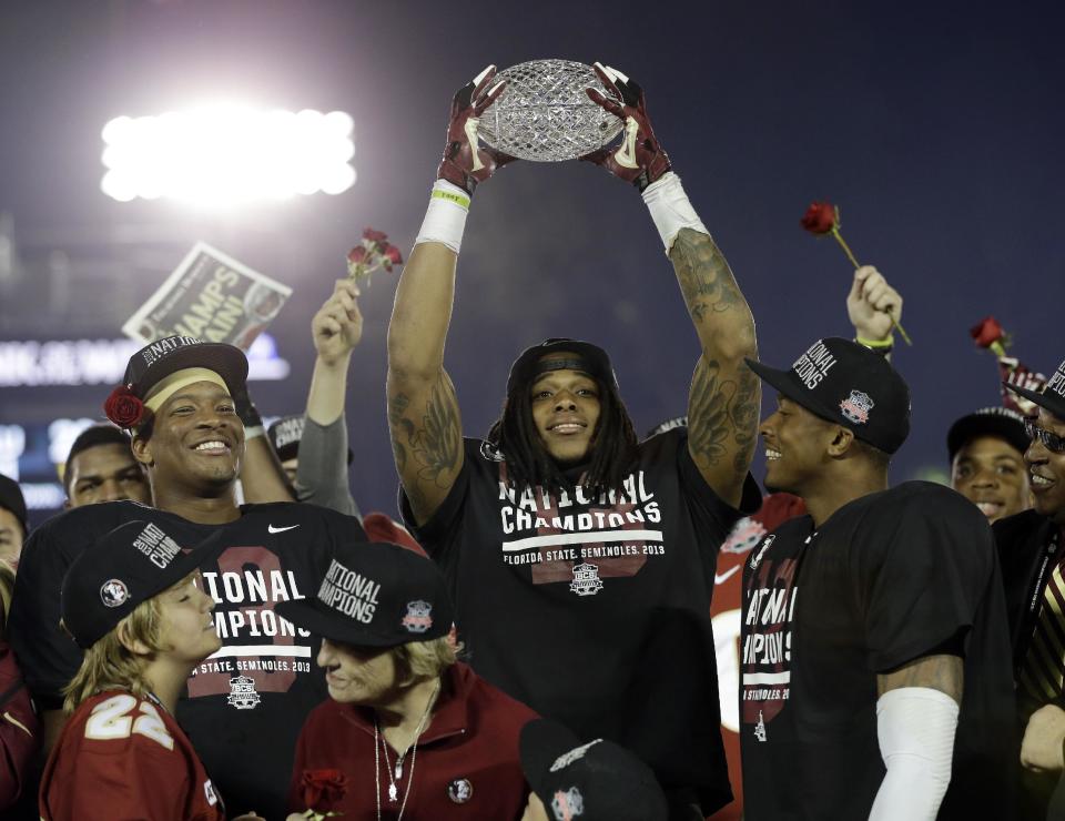 Florida State's P.J. Williams holds up his defensive player of the game trophy after the NCAA BCS National Championship college football game against Auburn Monday, Jan. 6, 2014, in Pasadena, Calif. Florida State won 34-31. (AP Photo/David J. Phillip)