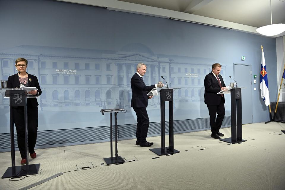 From left, Finland's Interior Minister Krista Mikkonen, Foreign Minister Pekka Haavisto and Defence Minister Antti Kaikkonen presents the report on changes in the foreign and security policy environment of Finland after Russia's attack to Ukraine in Helsinki, Finland, Wednesday, April 13, 2022. (Markku Ulander/Lehtikuva via AP)