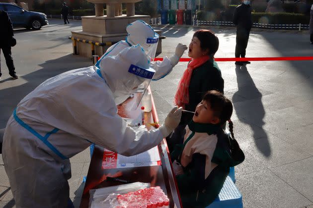 This photo taken on October 23, 2021 shows residents undergoing nucleic acid tests for the Covid-19 coronavirus in Zhangye in China's northwestern Gansu province. - China OUT (Photo by AFP) / China OUT (Photo by STR/AFP via Getty Images) (Photo: STR via Getty Images)