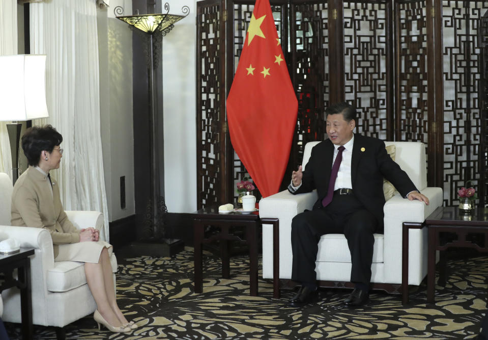 In this Monday, Nov. 4, 2019, photo released by China's Xinhua News Agency, Chinese President Xi Jinping, right, talks with Hong Kong Chief Executive Carrie Lam during a meeting in Shanghai, China. Lam is here for the second China International Import Expo (CIIE). (Ju Peng/Xinhua via AP)