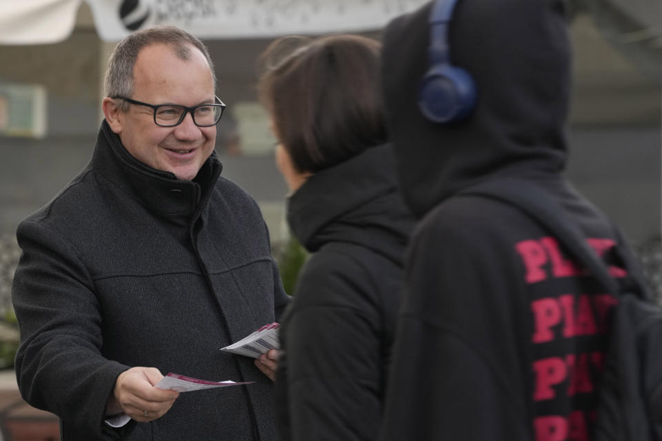 Adam Bodnar, a human rights lawyer, hands out flyers to morning commuters as he runs in his first election, for a seat in the Senate with the opposition Civic Coalition, in Warsaw, Poland, on Wednesday, Oct. 12, 2023. Bodnar for the opposition Civic Coalition. An expert on constitutional law, Bodnar, 46, says he believes the ruling party is turning Poland into a "semi-authoritarian state," along the same lines as Hungary, and he is running in hopes of helping to restore the legal system in accordance with the constitution. Concerns about democracy are driving the choice of many Poles as they prepare to vote in a national election Sunday viewed as the most important one since 1989. (AP Photo/Czarek Sokolowski)