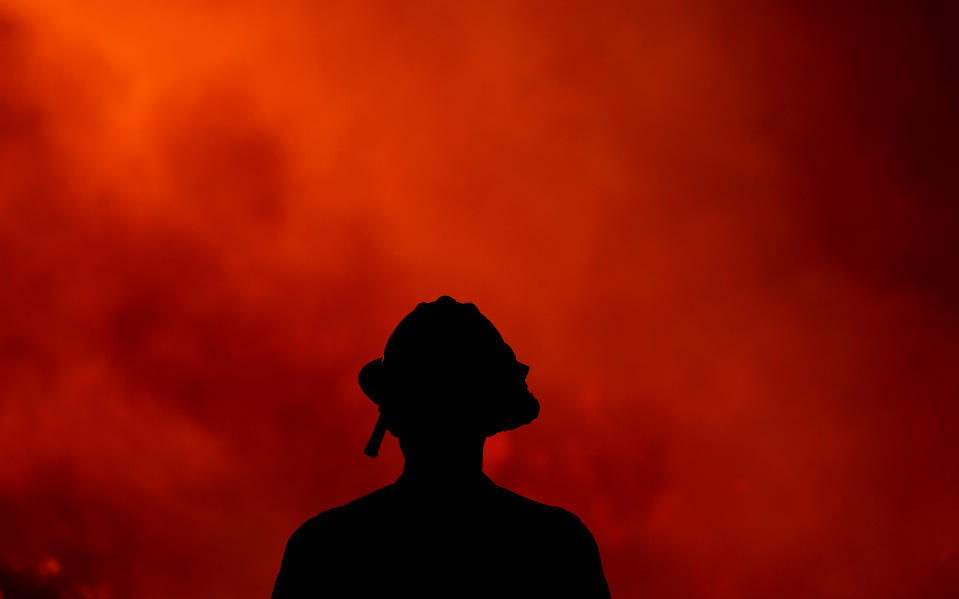 <p>A firefighter keeps watch on the Holy Fire burning in the Cleveland National Forest in Lake Elsinore, Calif., Thursday, Aug. 9, 2018. (Photo: Ringo H.W. Chiu/AP) </p>