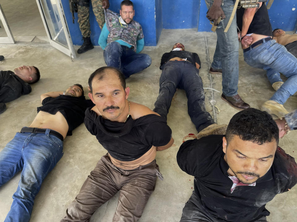 FILE - Suspects in the assassination of Haiti's President Jovenel Moise are shown to the media at police headquarters in Port-au-Prince, Haiti, July 8, 2021. Colombian President Iván Duque said Wednesday, April 13, 2022, that there is evidence and testimony that seriously implicates “practically all” of the former Colombian soldiers who are arrested in Haiti in relation to the assassination of Haitian President Jovenel Moïse. (AP Photo/Odelyn Joseph, File)