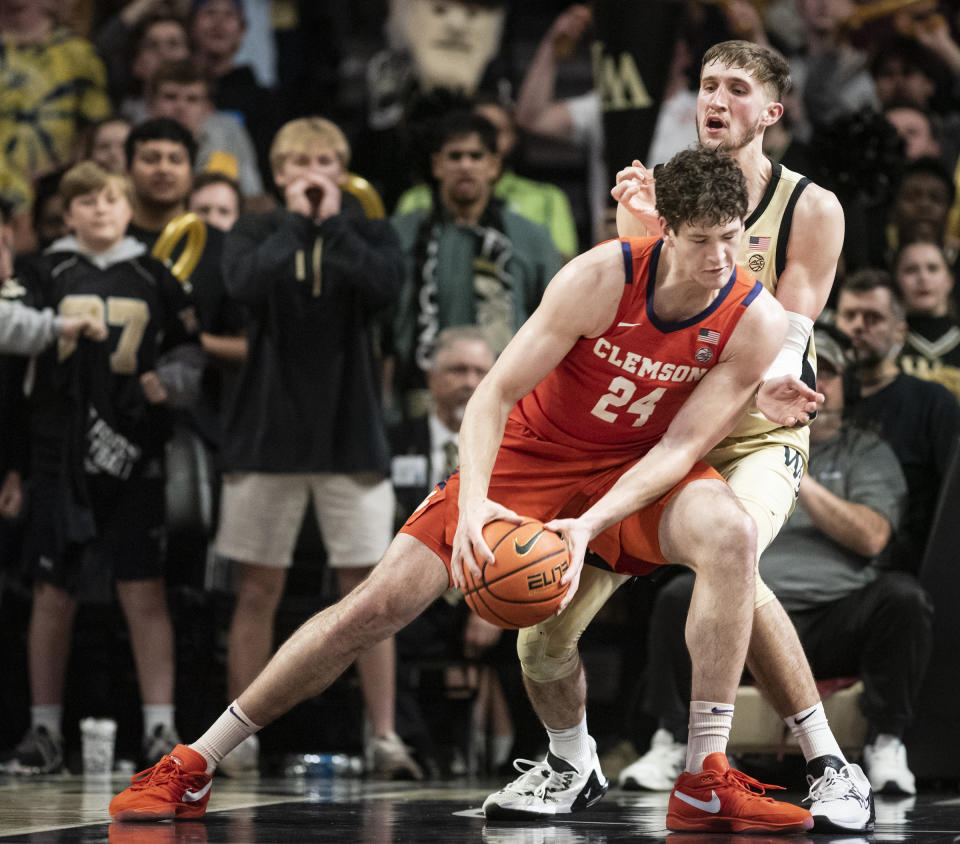 Clemson center PJ Hall (24) pushes past the defense of Wake Forest forward Andrew Carr (11) during the second half of an NCAA college basketball game, Saturday, March 9, 2024 in Winston-Salem, N.C. (Allison Lee Isley/The Winston-Salem Journal via AP)