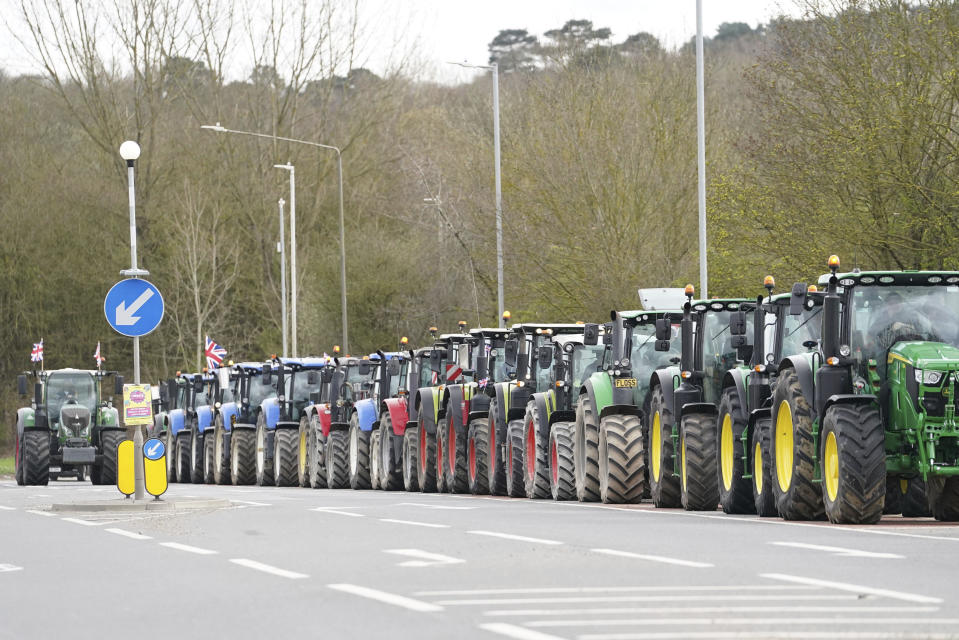 A convoy of farmers in tractors gather on the A20, near Wrotham, in Kent, England, before heading to London to join a protest in Westminster raising awareness of the difficulties for the British farming industry, Monday March 25, 2024. (Gareth Fuller/PA via AP)