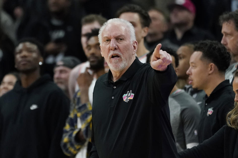 San Antonio Spurs head coach Gregg Popovich signals to his players during the second half of an NBA basketball game against the Utah Jazz, Friday, March 11, 2022, in San Antonio. The Spurs won, making Popovich the all-time winningest coach in NBA regular-season history. (AP Photo/Eric Gay)