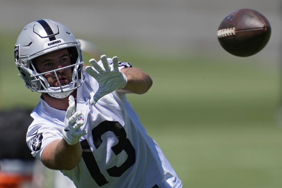 Las Vegas Raiders wide receiver Hunter Renfrow catches a pass during practice at the NFL football team's practice facility Thursday, June 2, 2022, in Henderson, Nev. (AP Photo/John Locher)