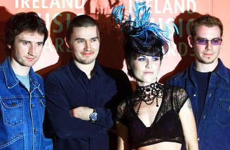 FILE PHOTO - Irish pop group The Cranberries (L-R) Noel Hogan, Mike Hogan, Dolores O'Riordan and Fergal Lawler pose for photographs after performing at the Meteor Ireland Music Awards at the Point Theatre in Dublin, March 4, 2002. REUTERS/Paul McErlane/File Photo