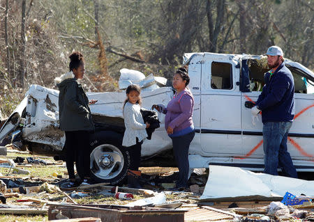 Residents of Sunshine Acres mobile home park search for items after being allowed into their homes after a tornado struck the mobile home park in Adel, Georgia. REUTERS/Tami Chappell