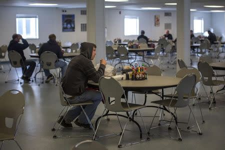 A man sits inside the Target Logistics Bear Paw Lodge man camp in Williston, North Dakota in this March 13, 2013 file photo. REUTERS/Shannon Stapleton/Files