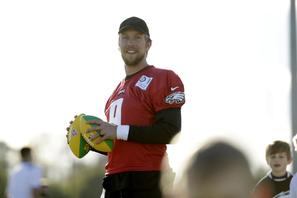 Philadelphia Eagles' quarterback Nick Foles joins in with an NFL Flag event for local schoolchildren after an NFL training session at the London Irish rugby team training ground in the Sunbury-on-Thames suburb of south west London, Friday, Oct. 26, 2018. The Philadelphia Eagles are preparing for an NFL regular season game against the Jacksonville Jaguars in London on Sunday. (AP Photo/Matt Dunham)