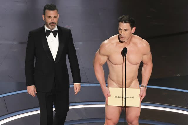 <p>Kevin Winter/Getty Images</p> Jimmy Kimmel and John Cena take the stage at the 96th Annual Academy Awards